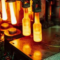 Close-up of glass bottles in a manufacturing process at a factory in Dar es Salaam, Tanzania.